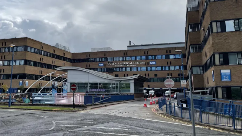 Two Men Arrested in Nottingham Mortuary Investigation Linked to Maternity Failures Police Action in Operation Perth Two men, aged 55 and 59, have been arrested in Nottingham over concerns linked to practices in a hospital mortuary service. They are suspected of misconduct in a public office. Police confirmed the arrests took place on Monday. Nottinghamshire Police are running the inquiry under Operation Perth, which started in 2023 after serious maternity care failings were identified at Nottingham University Hospitals NHS Trust. Background of the Maternity Investigation The investigation is tied to wider concerns that involve hundreds of cases where babies died or were harmed. The issues are part of a major maternity review in the NHS, which is one of the largest of its kind. The review is led by independent senior midwife Donna Ockenden. It covers around 2,500 cases and began in September 2022 after repeated allegations of poor care affecting mothers and newborns. Mortuary Service Under Scrutiny Nottingham University Hospitals NHS Trust runs mortuary services at both Queen’s Medical Centre and Nottingham City Hospital. These services operate under a licence from the Human Tissue Authority. Police say Operation Perth identified breaches of regulations under the Human Tissue Act. These breaches relate to how mortuary services were managed and run. Support for Affected Families Deputy Chief Constable Rob Griffin said the investigation may be distressing for families already involved in the case. He confirmed that families directly affected have been contacted. He added that more families will be informed as investigators identify further cases. Support services are also available through the Operation Perth information channels. Hospital Response Manjeet Shehmar, medical director at Nottingham University Hospitals NHS Trust, said the trust is aware of the arrests. He said the organisation is taking the matter seriously and will fully cooperate with the investigation.