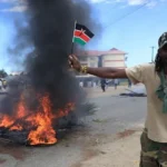 Two killed in Kenya protests over planned US Ebola isolation centre Violence erupts in Nanyuki Two people were killed in Nanyuki, a town in central Kenya, during protests linked to a proposed US Ebola isolation facility near a military base. The demonstrations turned chaotic as crowds blocked roads, burned tyres, and clashed with security forces. Police used tear gas to disperse protesters. One victim was a bystander, family says One of the dead has been identified as 27 year old Charles Mang’aro Mwangi. His family says he was not part of the protest and was simply going about his daily routine when he was shot. His mother, Joyce Wangari, said he had left to meet a friend after work in the evening. She said he was not carrying anything or involved in any confrontation when the shooting happened. The family also said they have not received official details from authorities. Second death still unclear The second victim was taken to hospital by soldiers and was already dead on arrival. Both bodies showed gunshot injuries, but officials have not confirmed how the shootings happened or who was responsible. Police have said they were not aware of any fatalities when asked by reporters, and no formal statement has clarified the incidents. Public anger over Ebola facility plan The protests were triggered by plans to set up a 50 bed Ebola isolation centre at Laikipia Airbase. The facility is expected to treat US citizens affected by an outbreak in the Democratic Republic of Congo and will be staffed by US medical teams. Local concern has grown over possible health risks and cross border infection. Kenya has not reported any Ebola cases so far. Legal challenge halts opening Kenya’s High Court has temporarily stopped the facility from opening after a rights group filed a case. The petition argued that the project could create serious public health risks.
