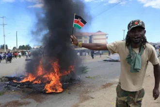 Two killed in Kenya protests over planned US Ebola isolation centre Violence erupts in Nanyuki Two people were killed in Nanyuki, a town in central Kenya, during protests linked to a proposed US Ebola isolation facility near a military base. The demonstrations turned chaotic as crowds blocked roads, burned tyres, and clashed with security forces. Police used tear gas to disperse protesters. One victim was a bystander, family says One of the dead has been identified as 27 year old Charles Mang’aro Mwangi. His family says he was not part of the protest and was simply going about his daily routine when he was shot. His mother, Joyce Wangari, said he had left to meet a friend after work in the evening. She said he was not carrying anything or involved in any confrontation when the shooting happened. The family also said they have not received official details from authorities. Second death still unclear The second victim was taken to hospital by soldiers and was already dead on arrival. Both bodies showed gunshot injuries, but officials have not confirmed how the shootings happened or who was responsible. Police have said they were not aware of any fatalities when asked by reporters, and no formal statement has clarified the incidents. Public anger over Ebola facility plan The protests were triggered by plans to set up a 50 bed Ebola isolation centre at Laikipia Airbase. The facility is expected to treat US citizens affected by an outbreak in the Democratic Republic of Congo and will be staffed by US medical teams. Local concern has grown over possible health risks and cross border infection. Kenya has not reported any Ebola cases so far. Legal challenge halts opening Kenya’s High Court has temporarily stopped the facility from opening after a rights group filed a case. The petition argued that the project could create serious public health risks.