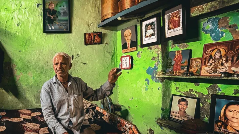 We Don’t Look at the Sky Anymore: Families Living with the Ahmedabad Air Crash Tragedy Introduction Ahmedabad is still living with the memory of a devastating air crash that killed 260 people. Most were passengers on the plane, but 19 people on the ground also lost their lives when the aircraft struck the BJ Medical College hostel area near the airport. One year later, grief has not faded for families who live nearby. Lives Changed in an Instant Prahlod Thakur lost his wife, Sarlaben, and his granddaughter, Aadhya. They were inside the hostel complex when the crash happened. Their photos still hang on the walls of his home. He sees them every morning. The loss remains heavy, and he often feels overwhelmed when he looks at their pictures. A Site That Never Healed The hostel building still shows clear damage. Upper floors remain open to the sky. Concrete is broken and scattered. Stairs are dark with burn marks. Personal items are still buried in dust and debris. The building has not returned to normal use. Plans exist to demolish it and rebuild, but no full cleanup has taken place yet. Daily Life Around the Ruins Students continue their studies nearby. They walk past the damaged building every day. Air traffic still passes overhead frequently. Before the crash, the sound of planes felt normal. Now it brings back painful memories for many residents and students. Grief That Does Not Fade For families like Thakur’s, healing feels out of reach. The sound of a passing aircraft brings back the same shock they felt during the disaster. Many say they avoid looking at the sky. The tragedy has changed how they experience everyday life. Future Plans and Uncertain Closure Authorities have approved demolition of the damaged hostel complex. A new building is planned for the site. However, the delay in removal of the wreckage has kept the emotional wound open for many families and students.