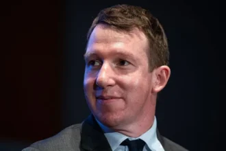 AI needs a “brake pedal” to prevent unchecked growth, warns Anthropic co founder Key concern over fast AI progress Anthropic co founder Jack Clark has raised concerns about how quickly artificial intelligence is advancing. He warned that AI systems may soon reach a stage where they can improve and generate code with very little human involvement. Speaking to BBC Newsnight, Clark said the industry currently has strong momentum but lacks proper control mechanisms. He explained that the field is moving forward rapidly, but safety and governance tools are not keeping pace. Call for stronger regulation and oversight Clark stressed that governments and policymakers need to stay in control of AI development. He said future systems will become more powerful and will have wider effects on jobs, society, and decision making. He argued that regulation should give society the ability to slow down AI progress when needed. According to him, the goal is to ensure humans remain in charge of how these systems evolve. AI systems already writing most of their own code Clark revealed that Anthropic’s chatbot Claude already generates around 80 percent of its own code. He suggested that reaching full automation in coding could happen within two years, a shift he described as highly significant. Such progress, he warned, could reshape how AI companies operate and how software is built across the industry. Debate over government action and industry responsibility Despite these concerns, major AI companies, including Anthropic, OpenAI, and Google, continue to advance their systems without pausing research. Clark noted that the US approach to regulation remains relatively flexible, with limited mandatory safety checks. He compared the situation to the early oil industry, where rapid growth eventually led to formal rules that helped stabilize the sector. He believes AI will require a similar framework to maintain public trust and reduce risks. Rapid growth and rising valuations Anthropic has expanded quickly since its launch five years ago. The company is now preparing for a public stock market listing, which could make it one of the most valuable tech offerings in history. Investors estimate its value could reach nearly one trillion dollars. Clark said the company’s public warnings are not about marketing or reputation. Instead, he said the aim is to share honest insights about how fast the technology is evolving inside leading AI labs.