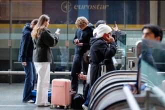 # EU Entry/Exit System Sparks Concerns Over Summer Travel Delays Travellers heading to Europe this summer may experience longer waiting times at airports because of the European Union's new Entry/Exit System (EES). The digital border control program has now become fully operational across the Schengen Area and is changing the way non-EU visitors enter and leave participating countries. Many travel experts have warned that the new checks could create delays during peak holiday periods. As millions of people travel across Europe, airports are preparing for increased passenger processing times. ## What Is the EU Entry/Exit System? The EU Entry/Exit System is a digital border management program designed to replace traditional passport stamping. Instead of receiving a manual stamp, travellers now have their entry and exit information recorded electronically. The system applies to non-EU citizens entering the Schengen Area. This includes UK travellers visiting popular destinations such as France, Spain, Portugal, Italy, Greece, and other participating countries. Officials introduced the system to improve border security and track the movement of visitors more accurately. ## What Information Must Travellers Provide? Under the new rules, travellers must complete biometric registration when entering the Schengen Area for the first time. This process includes: * A passport scan * Fingerprint registration * A digital facial photograph Most passengers complete these checks at automated kiosks located at airports. However, border officers may process some travellers manually. Children under 12 years old are generally exempt from fingerprint collection. Once travellers leave the Schengen Area, authorities verify the stored information to confirm their departure. ## Why Are Airport Delays Expected? The biometric registration process takes longer than a standard passport check. As a result, airport authorities expect increased waiting times, especially during busy travel periods. Since the rollout began last year, several airports have reported smooth operations. However, others have experienced significant delays during peak hours. Travel industry representatives believe some airports could face lengthy queues when passenger numbers rise sharply. In certain cases, travellers may wait several hours before clearing border control. ## What Should Travellers Do Before Flying? Passengers travelling to Europe should arrive at airports earlier than usual and allow extra time for border procedures. Checking airline guidance before departure can also help travellers prepare for any additional requirements. Furthermore, travellers should keep passports ready and follow airport instructions to speed up the registration process. Although the new system aims to strengthen security and modernize border management, it may take time before airports fully adjust to the additional checks. ## Outlook for Summer Travel The EU Entry/Exit System marks a major change in European border control procedures. While authorities expect the system to improve efficiency in the long term, travellers could experience delays during the busy summer season. For now, planning ahead and allowing extra time at airports remains the best way to avoid unnecessary stress and travel disruptions.