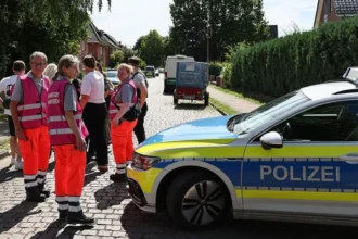 Six Dead After Shooting at Youth Welfare Centre in Germany, Suspect Arrested A tragic shooting at a youth welfare centre in Stade, northern Germany, has left six people dead and several others injured. Authorities arrested the suspected gunman and launched an investigation into what led to the deadly attack. Four Women Among the Victims Police confirmed that four women and one man died inside the welfare centre on Monday afternoon. Another victim later died in hospital after suffering critical injuries. Officials said all six victims were adults. Emergency crews rushed to the scene shortly after the shooting began. Several injured people also received treatment, although authorities have not released their identities or conditions. Large Police Response in Stade The shooting took place at a youth welfare facility on Dankersstrasse in Stade, a city located about 30 kilometres west of Hamburg. Police quickly secured the area and urged residents to stay away while officers carried out their investigation. A large number of police officers, medical teams, and emergency personnel responded to the incident. Authorities later announced that there was no further threat to the public. Suspect in Custody Police arrested the suspected shooter shortly after the attack. Investigators are also examining the possible involvement of two additional individuals. At this stage, officials have not revealed the motive behind the shooting. Detectives continue to gather evidence and interview witnesses to determine exactly what happened. Children Safe During the Incident Local media reports said the welfare centre housed women and children. Officials also confirmed that children at a nearby daycare centre remained inside during the incident for safety reasons. School-aged children in the area were later picked up by their parents after authorities secured the scene. Investigation Continues The city of Stade, home to around 50,000 residents, remains in shock following one of the deadliest incidents in the region in recent years. Investigators are expected to release more information as the inquiry continues. Authorities have asked anyone with information about the shooting to contact police as they work to establish the circumstances surrounding the tragedy.