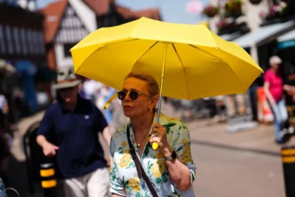 UK Heatwave Warning: Temperatures May Reach 40C as Rare Red Alert Issued Extreme heat alert across England and Wales A rare red weather warning has been issued for parts of England and Wales as an intense heatwave is expected to push temperatures close to 40C later this week. The alert covers London, southern England, the Midlands, and parts of south east Wales. The Met Office has warned that the conditions could cause major disruption and serious health risks. When the heatwave will peak The red warning is in place from Wednesday morning to Thursday night, with the highest temperatures expected during this period. Forecasters say highs could reach 39C to 40C in some areas, especially across southern England. An amber warning is also active across much of central and southern England and most of Wales from Monday through Thursday. Travel disruption and daily life impact Officials expect widespread disruption to transport, schools, and daily routines. Some schools have already announced early closures due to safety concerns. High humidity will make the heat feel even more intense, increasing discomfort and risk for people outdoors or without cooling. Health risks and official warnings Health experts have warned that this level of heat can cause serious illness, especially for older adults, young children, and people with existing health conditions. The UK Health Security Agency has issued a red heat health alert for several regions. It is only the second time such a warning has been used for heat. Dr Agostinho Sousa, a senior health protection official, urged people to take the warning seriously and check on vulnerable family members and neighbours. Night temperatures and tropical nights Temperatures may remain unusually high overnight, staying above 21C to 22C in some areas. These are known as tropical nights and can increase health strain because the body does not cool down properly. How this compares to UK records If temperatures reach 40C, they would come close to the UK’s highest recorded temperature of 40.3C, which was recorded in 2022. That record remains the highest temperature ever measured in the country.