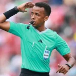 Somali Referee Omar Artan Denied Entry to US Despite Valid Visa Somali referee Omar Abdulkadir Artan has been denied entry into the United States ahead of the World Cup, even though he says he had valid travel documents and a proper visa. He was set to become the first Somali referee to officiate at a World Cup finals. However, he was stopped at Miami International Airport and sent back after an extended immigration process. Long Immigration Interview Before Repatriation Artan said immigration officials held him for an 11 hour interview upon arrival. After that, he was placed in a separate holding area for several hours. Later, he was put on a flight back to Istanbul. No official reason for the decision has been shared by US authorities. FIFA Confirms Removal from Tournament The global football governing body confirmed that Artan will not take part in the tournament. FIFA stated that host country immigration processes are outside its control. It added that officials were informed his entry status would not change. Because of tournament rules, he cannot continue training or officiating even at matches held outside the United States. Training Base Requirements in Miami All referees selected for the World Cup are required to stay at a training base in Miami. This setup is part of preparation and security planning for match officials. Refereeing chief Pierluigi Collina has organized this centralized training system for officials taking part in the tournament. Claims of Valid Documents and Visa Artan insisted that he had all required documents, including a valid visa and supporting travel papers. A Somali sports official also confirmed that he was traveling with proper authorization. Reports say a diplomatic passport had been arranged to support his travel after earlier visa issues. Political Context Around Immigration Rules The case comes amid stricter immigration rules affecting several countries, including Somalia. Earlier remarks from US leadership indicated concerns about Somali immigration, which has added sensitivity to the situation. Artan said he felt disappointed, adding that refereeing at the World Cup was the biggest dream of his career.