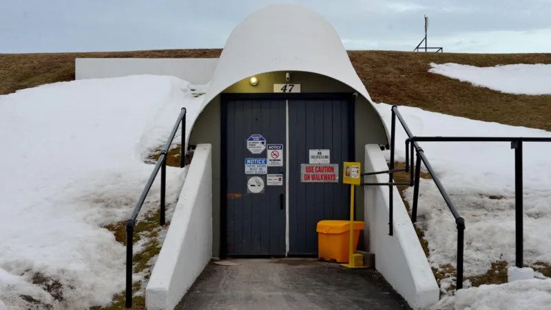 Cold War Bunker in Canada Set for Luxury Doomsday Condo Transformation Former Military Shelter Gets a New Purpose A massive Cold War era bunker in Nova Scotia, Canada, is being transformed into a luxury underground residential complex designed to protect its owners during major global emergencies. The project aims to combine high end living with advanced security, offering a unique option for people looking for a safe retreat during uncertain times. Located about 113 kilometers north of Halifax in the community of Debert, the underground structure was originally built as part of Canada's Cold War defence system. Today, developers believe it can serve a completely different purpose by becoming a secure residential destination for wealthy buyers. Luxury Living Beneath the Ground Canadian entrepreneur Jonathan Baha'i purchased the 64,000 square foot bunker in 2013 for approximately C$31,300. At first, he explored ideas such as historical tours, laser tag activities, and a small data center. However, growing concerns over global instability encouraged the development team to redesign the site as a luxury survival complex. The redevelopment will include 50 private condominium units equipped with premium features. Residents will have access to gourmet meals prepared from a self sustaining food system, biometric security, 24 hour surveillance, onsite medical facilities, and private wellness areas. Additional amenities will include a spa, yoga room, cigar lounge, and modern lighting systems designed to imitate natural daylight. Developers also plan to use an above ground bunker to grow fresh food for residents. Security Designed for Crisis Situations The project will feature advanced security systems to protect residents during emergencies. The development team has partnered with a German security company that specializes in protecting high profile clients. Planned security measures include drone surveillance, controlled entry systems, and continuous monitoring around the property. The nearby Debert Airport will provide convenient access for residents who travel by private aircraft. Condo Owners Can Also Earn Rental Income Developers have already sold several condominium units, although they have not revealed the purchase prices. When owners are away, their units can operate as luxury hotel accommodations, allowing them to earn a share of the rental income. If a real emergency occurs while guests are staying at the property, permanent owners will receive priority access to their units. A Historic Shelter with a Modern Future The Debert bunker was one of several government shelters built across Canada during the Cold War to protect officials in the event of a nuclear attack. Engineers designed the underground facility to survive a nearby nuclear explosion while supporting more than 300 people for at least 30 days. Advances in missile technology eventually reduced the bunker's military value. It later served as an emergency operations center before authorities closed it in 1996. Now, decades later, the historic structure is being reimagined as one of Canada's most unusual luxury real estate developments.