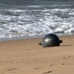 Australia Space Agency Identifies Likely Source of Mystery Space Balls Found on Queensland Beach Residents of northern Queensland were left surprised after six large silver spheres washed up on Forrest Beach near Townsville. At first, no one knew where the objects had come from, leading to widespread curiosity and safety concerns. The Australian Space Agency (ASA) has now identified the most likely source of the mysterious objects. According to the agency, the spheres appear to be pressure vessels from a space launch vehicle. Officials believe the objects are consistent with debris from a foreign rocket that recently re entered Earth's atmosphere. Although investigators have not yet confirmed the exact launch vehicle, the agency is working with international authorities to identify its origin. Authorities Secure the Area Local emergency services quickly responded after the discovery. The Queensland Fire Department created a 50 metre exclusion zone around the objects and warned residents not to approach or touch them. Officials advised anyone who finds a similar object to move away immediately and contact emergency services. Safety experts took extra precautions because the spheres could still contain dangerous substances. Specialist crews wearing protective suits carefully collected the metal balls. They placed them inside hazardous material containers while police secured the area. Authorities wanted to eliminate any possible risk before transporting the objects for further examination. Why Experts Considered the Objects Dangerous Some space experts suggested the spheres could be propellant or pressure tanks from a rocket. If that is correct, they may contain small amounts of highly flammable or chemically reactive materials left over from the launch. Although officials have not confirmed the presence of hazardous chemicals, they continue to treat the objects with extreme caution until testing is complete. Local Community Reacts The discovery quickly became the main topic of conversation in the quiet coastal community. Lisa Scobie, owner of Forrest Beach Takeaway, said unusual events rarely happen in the area. She explained that the arrival of emergency crews and investigators created excitement and curiosity among local residents, who wanted to know where the mysterious objects had come from. Similar Discoveries Have Happened Before This is not the first time space debris has reached Australian shores. In 2023, Indian authorities confirmed that a large metal dome found on a beach in Western Australia belonged to one of the country's Polar Satellite Launch Vehicles (PSLV). A similar metal sphere also appeared in remote grasslands in Namibia in 2011. Experts at that time believed it was a fuel or bladder tank from an unmanned rocket. They suspected it had once contained hydrazine, a highly volatile rocket propellant. Investigation Continues The Australian Space Agency continues to work with international partners to verify the rocket responsible for the debris. Investigators will examine the recovered objects before making a final determination. Until the investigation ends, authorities are asking the public to avoid any unidentified metal objects that could be connected to space launches and report them immediately to emergency services.