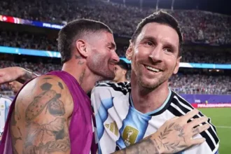How Argentina's Team Spirit Gives Lionel Messi the Perfect World Cup Stage Messi Finds Joy and Relief in Argentina's United Squad Lionel Messi has always carried high expectations whenever he wears Argentina's shirt. During the 2026 FIFA World Cup, those emotions have become even stronger as he aims to guide his country to another historic title. After Argentina recovered from two goals down to secure a dramatic place in the World Cup quarter finals, Messi could not hold back his emotions. His tears reflected more than happiness. They showed relief after missing a penalty earlier in the match, a mistake that briefly threatened Argentina's hopes. He also continues to deal with personal concerns after learning about his father's health problems earlier in the tournament. Despite those challenges, Messi appears happier than ever within the national team setup. The strong connection between the players has created an atmosphere where he feels relaxed, trusted, and fully supported. Lionel Scaloni Builds a Team Around Togetherness Argentina manager Lionel Scaloni believes success comes from unity rather than tactics alone. While formations remain important, he places greater value on friendship and togetherness inside the squad. The players regularly spend time together away from the pitch. They share traditional mate tea, enjoy barbecues, and play the popular Argentine card game Truco. These simple activities have strengthened relationships and created a close knit dressing room. As a result, Messi has rediscovered the enjoyment of representing his country. Surrounded by teammates who understand him both as a footballer and as a person, he looks more comfortable than he has in many previous international tournaments. Rodrigo De Paul Becomes Messi's Closest Ally One of the strongest friendships inside the Argentina camp is between Messi and Rodrigo De Paul. Their relationship started during international duty after De Paul noticed Messi spending time alone following a training session. He invited the captain to share mate and play cards, beginning a friendship that has only grown stronger. Now, the two share a daily routine. Every morning, Messi visits De Paul's room for mate before other teammates arrive. The tradition has become an important part of life inside the squad. Unlike many people who treat Messi as a global superstar, De Paul treats him like any other teammate. He jokes with him, calls him "El Pequeño," and knows when to offer support or give him space. That balance has helped Messi feel comfortable throughout the tournament. Argentina Players Rally Around Their Captain The entire Argentina squad openly shows its admiration for Messi. Many players grew up watching him and credit him for inspiring their own football careers. Before matches, De Paul often walks beside Messi as the team enters the field, while the rest of the players follow closely behind. The image reflects a squad determined to protect and support its captain in every situation. The players also wear the same Adidas Messi boots as a symbol of unity. On Messi's birthday, the squad celebrated by wearing shirts featuring old photographs taken with him during different stages of his international career. These gestures highlight the respect and affection that exist within the group. Teamwork Gives Argentina Confidence Argentina's success has not depended on individual brilliance alone. The team's chemistry, trust, and shared purpose have created the ideal environment for Messi to perform at his best. As the World Cup reaches its final stages, Argentina believe their greatest strength is not only the world's greatest player but also the close bond shared by every member of the squad. That unity could prove decisive as they continue their pursuit of another world championship.