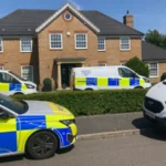 A murder investigation is underway after a mother and her two children were found dead inside a home in Great Denham, a residential area near Bedford. Police discovered the victims after forcing entry into the property when relatives and neighbours became concerned because the family had not been seen for several days. The tragic discovery has shocked the local community. Detectives are now working to establish the exact circumstances surrounding the deaths while carrying out a detailed investigation. Police Respond After Family Goes Missing Officers attended a property on Carnoustie Drive on Monday following reports that the family had not been seen for several days. After entering the home, police found the bodies of a woman and her two children. Emergency services secured the area while specialist investigators began gathering evidence. Forensic teams continue to examine the property as detectives interview witnesses and collect information that could help the investigation. Police Identify Suspect Investigators have confirmed that they identified a suspect who was known to all three victims. Early findings suggest the suspect has already left the country. Police officers are working with national and international agencies to trace the individual and determine their current location. Authorities have not released the suspect's identity because the investigation remains active. Investigation Continues Assistant Chief Constable John Murphy described the case as deeply distressing and confirmed that investigators believe the mother and her two children were murdered. He said the investigation remains in its early stages and requires significant resources. Detectives are examining evidence, reviewing information, and following every possible lead to establish what happened and identify everyone involved. Increased Police Presence in Great Denham Police have reassured residents that there is no evidence of any wider threat to the public. Even so, officers have increased patrols across Great Denham to provide reassurance and maintain a visible presence in the area. Local residents can expect to see more uniformed officers while detectives continue their inquiries. Authorities have urged anyone with information that may assist the investigation to contact the police. Community Shocked by Tragic Incident The deaths of the mother and her two children have deeply affected the Great Denham community. As investigators continue their work, police remain focused on uncovering the full circumstances surrounding the case and bringing the person responsible to justice. The investigation is ongoing, and further updates are expected as new information becomes available.