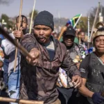South Africa Deports More Than 53,000 Foreign Nationals in Migration Crackdown South Africa has deported and repatriated more than 53,000 foreign nationals as the government continues a major campaign against undocumented migration. The action comes after weeks of protests calling for stronger border controls and the removal of people living in the country without legal documents. The government said most of those affected came from Malawi, Zimbabwe, and Mozambique. Officials expect the number to increase as immigration operations continue across the country. Anti Immigration Protests Increase Pressure on Government The crackdown follows growing anger among some South African communities over undocumented migration. Protesters have accused foreign nationals of worsening unemployment, increasing crime, and putting pressure on public services. Several demonstrations have taken place across the country, with activists demanding stricter immigration policies. Some groups have also called for regular protests until the government takes stronger action. However, international organisations have warned against blaming migrants for South Africa’s economic problems. The United Nations has urged authorities and citizens to avoid using migrants as scapegoats for challenges such as poverty and unemployment. Government Confirms Deportation Numbers South Africa’s Justice and Constitutional Development Minister Mmamoloko Kubayi said authorities had processed 53,499 foreign nationals for deportation and repatriation. She explained that the majority were Malawian citizens, followed by Zimbabweans and Mozambicans. According to the minister, the operation has also helped police identify people wanted for alleged criminal offences. Kubayi said the government wants to create an organised migration system that respects both national laws and human rights. She added that immigration officials will continue enforcing the country’s rules but warned protesters against carrying out illegal searches of homes and businesses. Foreign Nationals Leave Amid Rising Tensions The protests have created fear among some migrant communities. Reports suggest that many foreign nationals have left South Africa because of threats, intimidation, and concerns about possible violence. Countries including Ghana, Nigeria, Uganda, and Kenya have helped some citizens return home through organised flights. South African President Cyril Ramaphosa has recognised public concerns about immigration but has strongly condemned attacks against migrants. He urged citizens to allow law enforcement agencies to handle immigration issues instead of taking matters into their own hands. South Africa Faces Migration Challenges South Africa remains one of Africa’s strongest economies and continues to attract migrants searching for jobs and better living conditions. Many foreign nationals enter the country legally, while others cross borders without proper documents. The government says it will continue managing migration while balancing public concerns with the rights and dignity of all people living in South Africa.