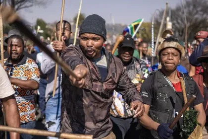 South Africa Deports More Than 53,000 Foreign Nationals in Migration Crackdown South Africa has deported and repatriated more than 53,000 foreign nationals as the government continues a major campaign against undocumented migration. The action comes after weeks of protests calling for stronger border controls and the removal of people living in the country without legal documents. The government said most of those affected came from Malawi, Zimbabwe, and Mozambique. Officials expect the number to increase as immigration operations continue across the country. Anti Immigration Protests Increase Pressure on Government The crackdown follows growing anger among some South African communities over undocumented migration. Protesters have accused foreign nationals of worsening unemployment, increasing crime, and putting pressure on public services. Several demonstrations have taken place across the country, with activists demanding stricter immigration policies. Some groups have also called for regular protests until the government takes stronger action. However, international organisations have warned against blaming migrants for South Africa’s economic problems. The United Nations has urged authorities and citizens to avoid using migrants as scapegoats for challenges such as poverty and unemployment. Government Confirms Deportation Numbers South Africa’s Justice and Constitutional Development Minister Mmamoloko Kubayi said authorities had processed 53,499 foreign nationals for deportation and repatriation. She explained that the majority were Malawian citizens, followed by Zimbabweans and Mozambicans. According to the minister, the operation has also helped police identify people wanted for alleged criminal offences. Kubayi said the government wants to create an organised migration system that respects both national laws and human rights. She added that immigration officials will continue enforcing the country’s rules but warned protesters against carrying out illegal searches of homes and businesses. Foreign Nationals Leave Amid Rising Tensions The protests have created fear among some migrant communities. Reports suggest that many foreign nationals have left South Africa because of threats, intimidation, and concerns about possible violence. Countries including Ghana, Nigeria, Uganda, and Kenya have helped some citizens return home through organised flights. South African President Cyril Ramaphosa has recognised public concerns about immigration but has strongly condemned attacks against migrants. He urged citizens to allow law enforcement agencies to handle immigration issues instead of taking matters into their own hands. South Africa Faces Migration Challenges South Africa remains one of Africa’s strongest economies and continues to attract migrants searching for jobs and better living conditions. Many foreign nationals enter the country legally, while others cross borders without proper documents. The government says it will continue managing migration while balancing public concerns with the rights and dignity of all people living in South Africa.