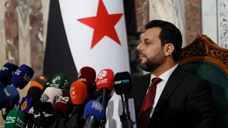 # Syria’s New Parliament Takes Shape as President Ahmed al Sharaa Appoints Final 70 Lawmakers Syria has completed the formation of its new transitional parliament after Interim President Ahmed al Sharaa appointed the remaining 70 lawmakers. The move completes the 210 seat People's Assembly and prepares the legislature for its first session next week. The appointments mark another step in Syria's political transition after the fall of former President Bashar al Assad in 2024. Officials say the new parliament will guide the country's legislative work during the transitional period. ## Final Appointments Complete the Assembly The president selected the final 70 lawmakers after regional electoral colleges had already chosen the other 140 members last October. Officials designed the latest appointments to improve representation across different sections of Syrian society. Among the newly appointed lawmakers, 15 are women. Another 13 members spent time in prison during the rule of Bashar al Assad. The government has not confirmed how many members belong to Syria's religious and ethnic minority communities. Mohammed Taha al Ahmed, chairman of the Higher Committee for the Syrian People's Assembly Elections, said the appointments combine experience with the sacrifices made by many Syrians during years of conflict. ## Parliament Aims to Represent Different Communities According to election officials, the new lawmakers include academics, professionals, community leaders, experts, survivors of detention, relatives of people killed during the war, and victims of chemical attacks. The appointments also cover all 14 Syrian provinces. Two of the newly selected lawmakers come from Suweida, a province with a large Druze population. Officials believe this broader representation will strengthen national unity and ensure that different voices take part in the country's political transition. ## Delays Continue in Some Areas Authorities have not held electoral college voting in Suweida because security conditions remain unstable. The province has stayed outside full government control since deadly sectarian clashes last July left around 1,700 people dead. Election officials said they plan to organize voting there once conditions improve. Authorities also delayed elections in parts of Raqqa and Hassakeh after government forces regained control of those areas from the Kurdish led Syrian Democratic Forces earlier this year. ## Critics Question the Electoral Process Several Kurdish political parties rejected the lawmakers selected through the electoral colleges. They argued that the process excluded important political groups and failed to provide fair representation. Civil society organizations also raised concerns about the structure of the elections. They said the president's influence over the Higher Committee and electoral colleges limits the independence of the parliament. The groups also questioned the president's authority to appoint one third of the assembly and replace lawmakers if seats become vacant. They warned that these powers could reduce the parliament's independence. ## UN Calls the Transition a Critical Moment The United Nations continues to monitor developments in Syria. Last week, UN Deputy Special Envoy Claudio Cordone told the Security Council that the country's transition has reached a critical stage. He said Syria now faces both important opportunities and serious challenges as it works toward political stability and long term peace. The new parliament is expected to begin its first session next week. Its decisions could play an important role in shaping Syria's future during the country's ongoing transition.