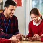 Teachers in England to Receive 3.5% Pay Rise From September Teachers across England will receive a 3.5% pay rise from September, with another 3% increase planned for the following year, according to the Department for Education. The government says the decision reflects its commitment to supporting teachers while also providing additional funding for schools. The government has allocated £1.8 billion in extra funding for education. However, schools will need to cover the first 1% of each pay increase from their existing budgets. Officials believe this approach will help balance higher salaries with responsible public spending. Government Introduces New Rules on Academy Executive Pay Alongside the pay announcement, the government has introduced new measures to limit the salaries of senior leaders in academy trusts. From September, academy trusts must seek government approval before advertising executive roles with salaries above £174,000. In addition, academy executives will no longer be allowed to receive pay rises that exceed those given to classroom teachers. Education Secretary Bridget Phillipson said teachers deserve fair recognition for the work they do every day. She also said executive salaries should not grow faster than teachers' pay and explained that the new rules will help prevent excessive pay increases for senior leaders. Teaching Union Still Considering Strike Action Despite the pay award, the National Education Union (NEU) has not ruled out industrial action. The union had previously warned that it would hold a formal strike ballot in the autumn if the government failed to improve its original pay proposal. Following the latest announcement, an NEU spokesperson said the union is still reviewing its options. General Secretary Daniel Kebede argued that the pay increase does not fully address the financial pressure facing schools. He said schools will still have to find part of the funding from their existing budgets, which could lead to spending cuts in other areas. According to Kebede, the union believes education should receive full funding instead of asking schools to absorb additional costs. The NEU's national executive committee is expected to meet next week to decide its next steps. Former Teacher Says Wellbeing Is the Bigger Challenge Former primary school teacher Jessica Featonby, who now runs an education technology company, welcomed higher salaries but said pay alone will not solve the challenges facing the profession. She explained that many teachers regularly work early mornings, evenings, weekends, and even school holidays without additional pay. In her view, reducing workload and improving staff wellbeing are just as important as increasing salaries. Featonby believes better working conditions would encourage more teachers to stay in the profession and help schools improve long term staff retention. What the Pay Rise Means The latest pay settlement offers teachers a higher salary over the next two years while introducing tighter controls on executive pay in academy trusts. However, concerns remain over how schools will fund part of the increase, leaving ongoing debate between the government and teaching unions about the future of education funding in England.