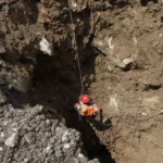 Rescue workers search a damaged hydropower tunnel after severe flooding in Nepal.