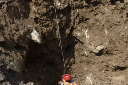 Rescue workers search a damaged hydropower tunnel after severe flooding in Nepal.