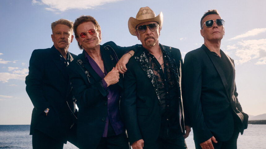 U2 band members performing live during a concert.