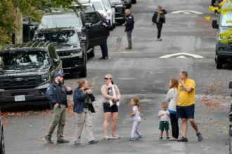 Homeland Security officers outside Representative Ilhan Omar’s Washington residence during a federal search on October 12, 2026.