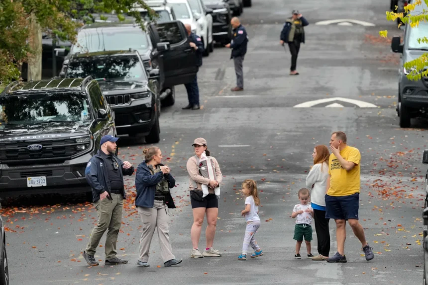 Homeland Security officers outside Representative Ilhan Omar’s Washington residence during a federal search on October 12, 2026.