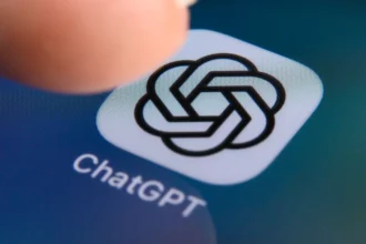 Illustration of a teenager using an AI chatbot with online safety symbols.