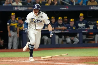 Tampa Bay Rays players celebrate after scoring the winning run against the Milwaukee Brewers.