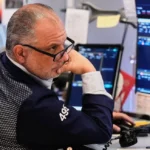 Stock market trading screens showing US equities and technology stocks.