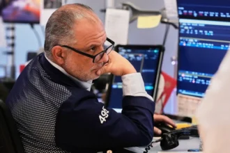 Stock market trading screens showing US equities and technology stocks.