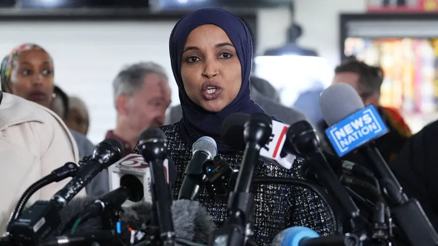 Homeland Security officer walks along a Washington, D.C., street during the October 12, 2026, investigation at Representative Ilhan Omar's residence.